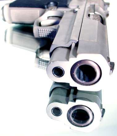 gun laying down with barrel pointed towards camera