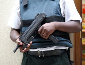 armed guard carrying uzi submachine gun